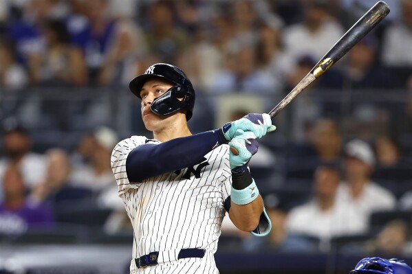 New York Yankees' Aaron Judge follows through on a home run against the Los Angeles Dodgers during the eighth inning of a baseball game, Sunday, June 9, 2024, in New York. (AP Photo/Noah K. Murray)