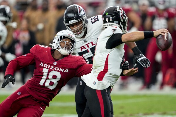Arizona Cardinals linebacker BJ Ojulari (18) sacks Atlanta Falcons quarterback Taylor Heinicke (4) during the second half of an NFL football game, Sunday, Nov. 12, 2023, in Glendale, Ariz. (AP Photo/Matt York)