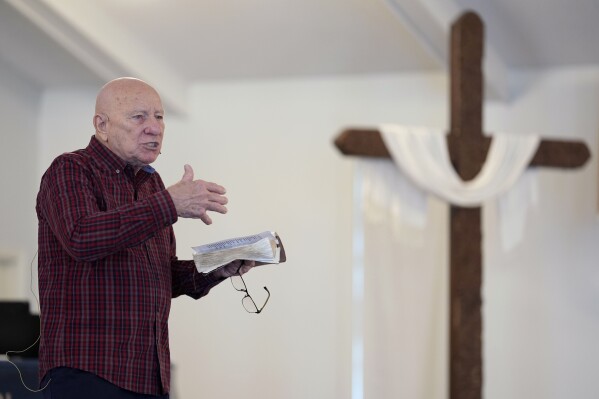 First Church of God Pastor Charles Hundley leads the morning service, Sunday, Jan. 7, 2024, in Des Moines, Iowa. Former President Donald Trump and his rivals for the GOP nomination have pushed for endorsements from pastors and faith communities. Evangelicals and religious Christian groups are traditionally critical to the Republican caucuses. (AP Photo/Charlie Neibergall)