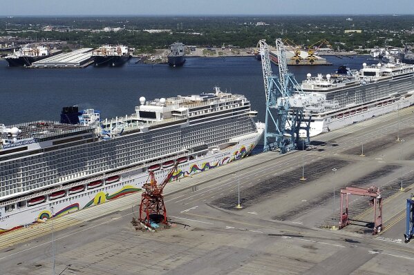 FILE - In this May 4, 2020 file photo, Norwegian cruise ships are docked at Portsmouth Marine Terminal in Portsmouth, Va. Norwegian Cruise Line is announcing plans to resume sailing after being shut down for more than a year by the pandemic. Norwegian said Tuesday, May 4, 2020,  that it plans trips in late July in the Greek islands and in August in the Caribbean.  (Stephen M. Katz/The Virginian-Pilot via AP, File)
