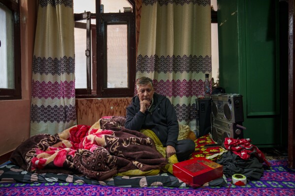 Abdul Hamid Khan listens to Kashmiri Sufi music on a tape recorder in his room in downtown Srinagar, Indian controlled Kashmir, Friday, Feb. 21, 2025. (AP Photo/Dar Yasin)