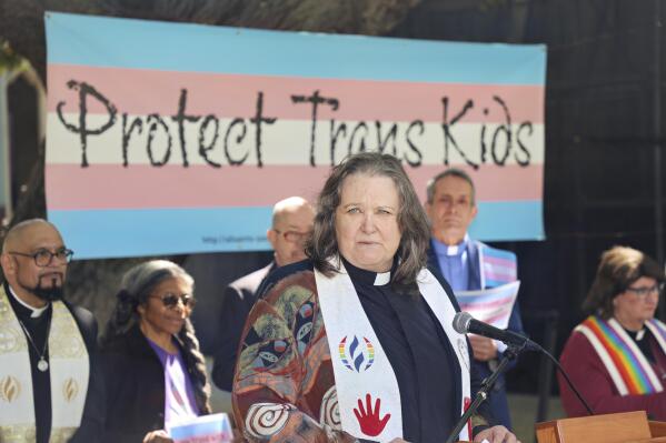 In this photo provided by Dirk Bolle, the Rev. Pat Langlois, senior pastor of MCC Church of Christ of the Valley, speaks at an interfaith rally in Pasadena, Calif., on March 31, 2023, protesting the wave of anti-transgender bills being enacted in numerous Republican-governed states. “These bills are the most vitriolic and cruel legislation I’ve seen,” she said. “I have a non-binary teenager, so I take this really personally, not just as a person of faith and as a lesbian, but as a mom.” Langlois, whose LGBTQ activism spans several decades, described the current situation as “probably the scariest time” because of the array of hostile bills. (Dirk Bolle via AP)