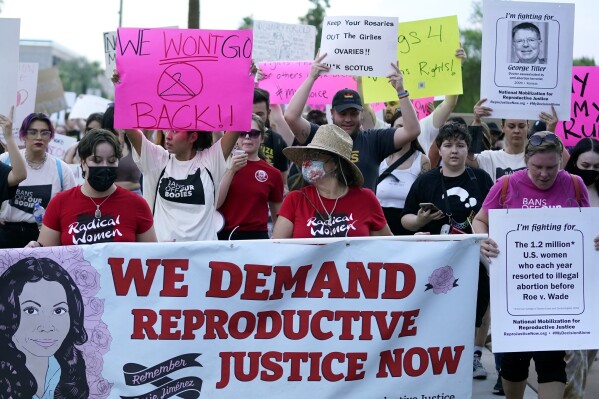 FILE - Thousands of protesters march around the Arizona Capitol after the Supreme Court decision to overturn the landmark Roe v. Wade abortion decision Friday, June 24, 2022, in Phoenix. Gov. Katie Hobbs on Friday, June 23, 2023 signed a sweeping executive order to protect anyone involved with a legally obtained abortion from prosecution. (AP Photo/Ross D. Franklin, File)
