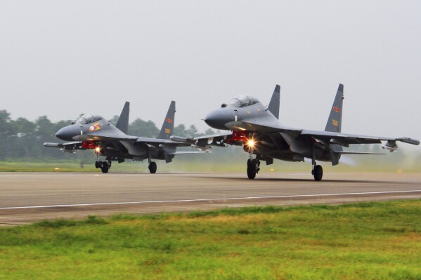 FILE - In this undated file photo released on Aug. 6, 2016, by China's Xinhua News Agency, two Chinese Su-30 fighter jets take off from an unspecified location to fly a patrol over the South China Sea. Taiwan’s defense ministry said Saturday, Aug. 26, 2023, that China sent dozens of aircraft and vessels toward the island, just days after the United States approved a proposed $500-million arms sale to Taiwan. (Jin Danhua/Xinhua via AP, File)
