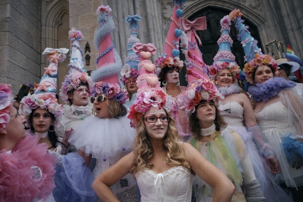 Revelers wearing decorated hats and costumes participate in the annual Easter Parade and Bonnet Festival in front of St. Patrick's Cathedral on Sunday, April 20, 2025, in New York. (AP Photo/Andres Kudacki)
