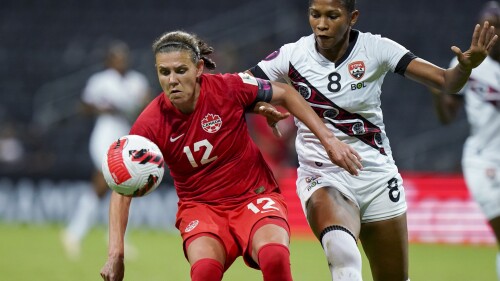 FILE - Canada's Christine Sinclair (12) and Trinidad and Tobago's Victoria Swift compete for the ball during a CONCACAF women's championship soccer match in Monterrey, Mexico, July 5, 2022. (AP Photo/Fernando Llano, File)