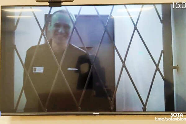 FILE This photo taken from video released by Russian Federal Penitentiary Service via SOTAVISION shows Russian opposition leader Alexei Navalny appears via a video link from the Arctic penal colony in Kharp, in the Yamalo-Nenetsk region about 1,900 kilometers (1,200 miles) northeast of Moscow, where he is serving a 19-year sentence, in Kovrov, Russia, on Feb. 15, 2024. Shortly after Navalny's death was reported on Friday Feb. 16, 2024, the Russian SOTA social media channel shared images of the opposition politician reportedly in court yesterday. In the footage, Navalny is seen standing up and is laughing and joking with the judge via video link. (Russian Federal Penitentiary Service via SOTAVISION via AP, File)
