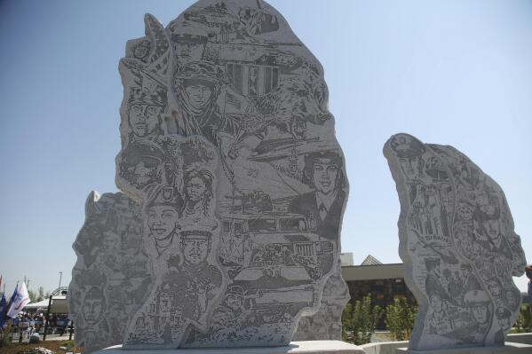 The Path of Honor memorial in Fort Washakie, Wyo., includes detained carvings honoring Native American service members, Thursday Aug. 12, 2021. (Cayla Nimmo/The Casper Star-Tribune via AP)