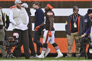 FILE - Cleveland Browns running back Kareem Hunt, center, walks off the field after an injury during the first half of an NFL football game against the Baltimore Ravens, Sunday, Dec. 12, 2021, in Cleveland. Hunt will likely miss Saturday's game against Las Vegas and could be out longer after injuring his ankle early in Cleveland's 24-22 win over Baltimore. (AP Photo/David Richard, file)