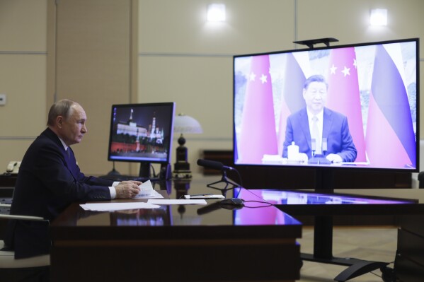 Russian President Vladimir Putin speaks with Chinese President Xi Jinping via videoconference at Novo-Ogaryovo state residence outside of Moscow, Russia, Tuesday, Jan. 21, 2025. (Gavriil Grigorov, Sputnik, Kremlin Pool Photo via AP)