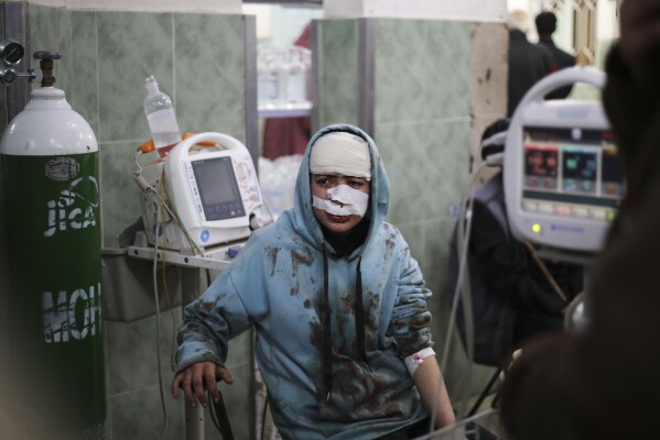 A Palestinian injured in an Israeli bombardment sits in a hospital in Rafah, Gaza Strip, Saturday, Feb. 10, 2024.  (AP Photo/Hatem Ali)