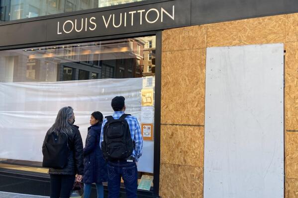 A security staff stands guard in front of a boutique of Louis