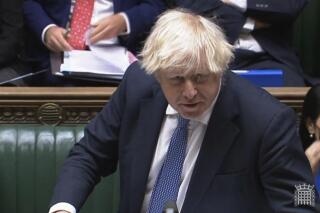 In this grab taken from video, Britain's Prime Minister Boris Johnson speaks during Prime Minister's Questions in the House of Commons, London, Wednesday, Dec. 8, 2021. Johnson says no U.K. government minister will attend the Beijing Olympics. Johnson on Wednesday called it “effectively” a diplomatic boycott. Johnson was asked in the House of Commons whether the U.K. will join the United States, Australia and Lithuania in a diplomatic boycott of the Winter Games. (House of Commons/PA via AP)