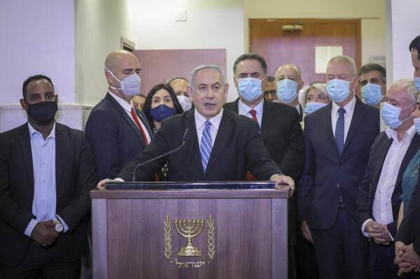FILE - Israeli Prime Minister Benjamin Netanyahu delivers a statement before entering the district court in Jerusalem, Sunday, May 24, 2020. Netanyahu's corruption trial has resumed after a month-long break. The resumption refocuses the spotlight on the long-serving leader's legal woes after a wave of protests over his government's plan to overhaul the country's judiciary. (AP Photo/Yonatan Sindel/Pool Photo via AP, File)