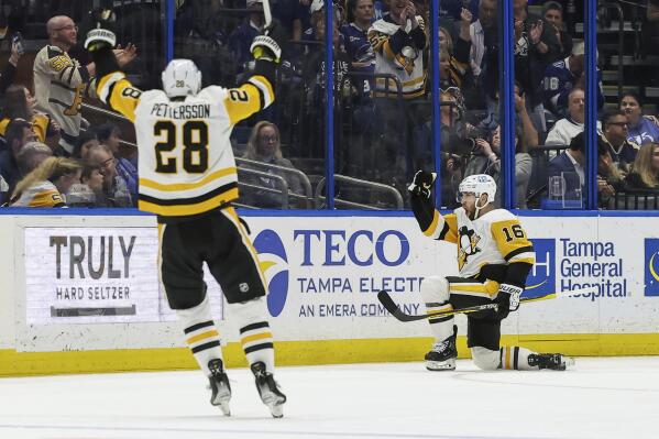 CORRECTS TO MARCH 2 NOT MARCH 1 - `Pittsburgh Penguins' Jason Zucker (16) celebrates after his goal against the Tampa Bay Lightning with Marcus Pettersson during the second period of an NHL hockey game Thursday, March 2, 2023, in Tampa, Fla. (AP Photo/Mike Carlson)
