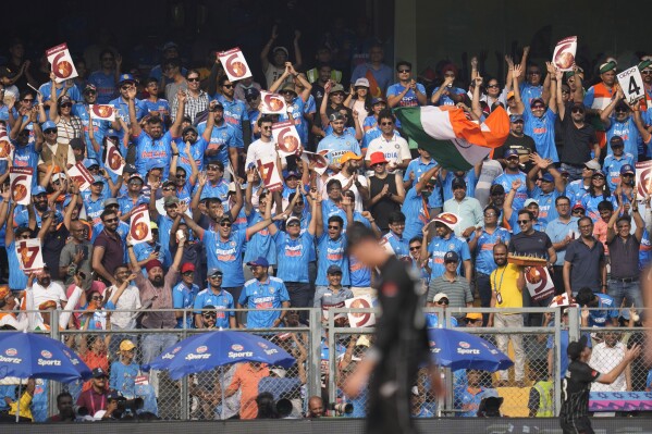 Spectators cheer for India during the ICC Men's Cricket World Cup first semi final match between India and New Zealand in Mumbai, India, Wednesday, Nov. 15, 2023. (AP Photo/Rafiq Maqbool)