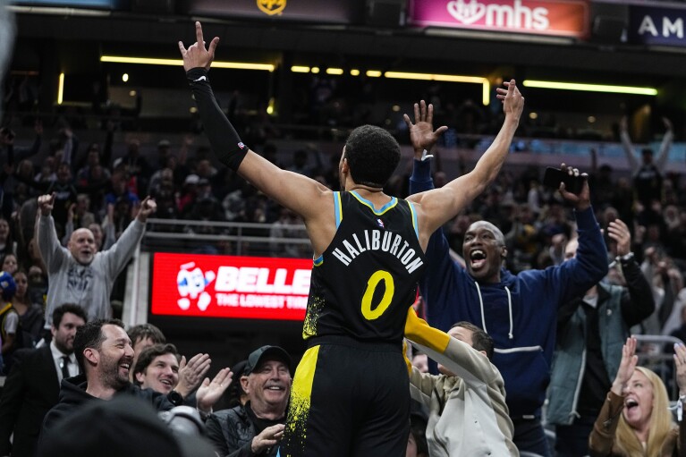 Indiana Pacers guard Tyrese Haliburton (0) celebrates after hitting a three-point basket against the Oklahoma City Thunder at the end of the third quarter in an NBA basketball game in Indianapolis, Friday, April 5, 2024. (AP Photo/Darron Cummings)