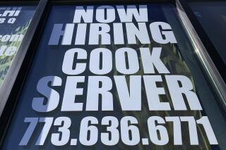 A hiring sign is displayed at a restaurant in Mount Prospect, Ill., Sunday, March 19, 2023. On Thursday, the Labor Department reports on the number of people who applied for unemployment benefits last week. (AP Photo/Nam Y. Huh)