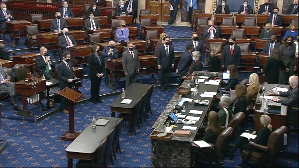 In this image from video, House impeachment managers arrive in the Senate chamber as they transmit the article of impeachment alleging incitement of insurrection against former President Donald Trump, in Washington, Monday, Jan. 25, 2021. Lead impeachment manager Rep. Jamie Raskin, D-Md., read the article of impeachment to the senators. (Senate Television via AP)
