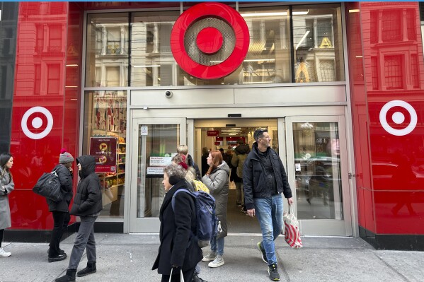 Shoppers walk from a Target store in midtown Manhattan in New York on Tuesday, March 19, 2024. On Tuesday, March 26, 2024, the Conference Board issues its latest monthly report on U.S. consumer confidence, which captures public responses on issues ranging from purchasing plans to the direction of inflation. (AP Photo/Ted Shaffrey)