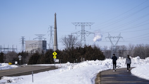 FILE - People walk on a trail at the Montissippi County Park near the Xcel Energy Monticello Generating Plant, a nuclear power plant, in Monticello, Minn., on Friday, March 24, 2023. (Renee Jones Schneider/Star Tribune via AP, File)