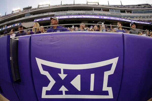FILE - The Big 12 Conference logo is displayed on a barrier at Amon G. Carter Stadium before Duquesne played against TCU in an NCAA college football game in Fort Worth, Texas, Sept. 4, 2021. TCU remained the smallest enrollment in the Big 12 Conference at 10,222, but the Horned Frogs made the College Football Playoff national championship game last season. Their basketball team then made the second round of the NCAA Tournament, and the baseball team went to the College World Series. (AP Photo/Ron Jenkins, File)