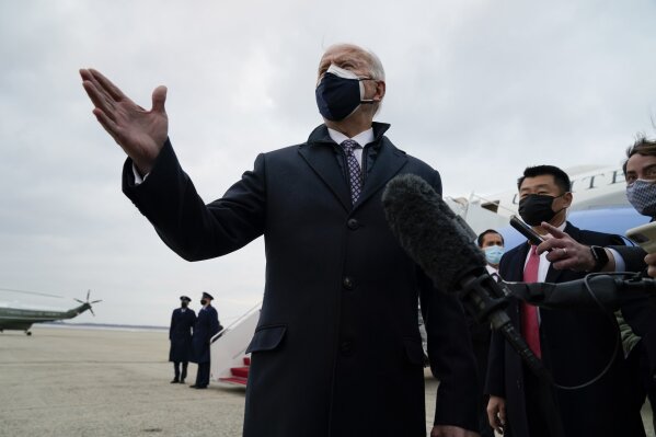 President Joe Biden speaks to member of the media after exiting Air Force One, Friday, Feb. 19, 2021, in Andrews Air Force Base, Md. (AP Photo/Evan Vucci)
