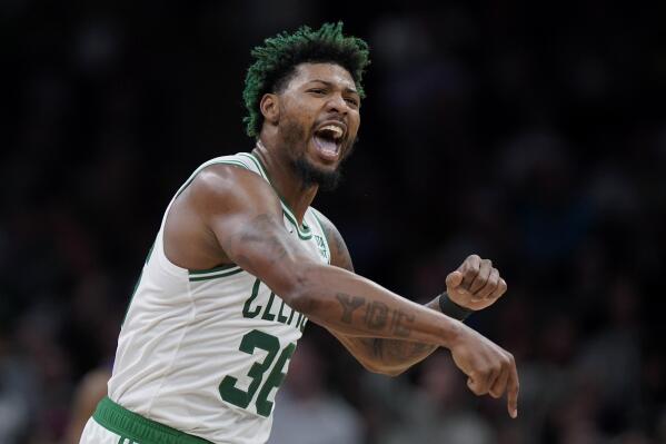 Boston Celtics guard Marcus Smart celebrates after the Celtics scored during the second half of an NBA basketball game against the Charlotte Hornets, Monday, Nov. 28, 2022, in Boston. (AP Photo/Steven Senne)