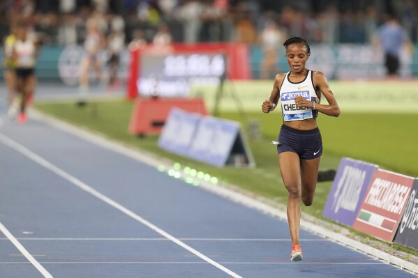 Beatrice Chebet, of Kenya, crosses the finish line to win the women 5000 meters at the Diamond League Golden Gala Pietro Mennea athletics meet at the Stadio Olimpico in Rome, Friday, June 6, 2025. (AP Photo/Gregorio Borgia)