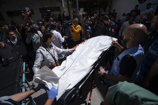 Members of the World Central Kitchen aid group, transports the body of one of the six foreign aid workers who were killed in an Israeli strike, at a hospital morgue in Rafah, Wednesday, April 3, 2024. (AP Photo/Fatima Shbair)
