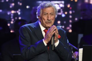 FILE - Singer Tony Bennett performs at the Statue of Liberty Museum opening celebration in New York on May 15, 2019. Bennett has been diagnosed with Alzheimer’s disease but the diagnosis hasn’t quieted his legendary voice. The singer’s wife and son reveal in the latest edition of AARP The Magazine that Bennett was first diagnosed in 2016. The magazine says he endures “increasingly rarer moments of clarity and awareness.” (Photo by Evan Agostini/Invision/AP, File)