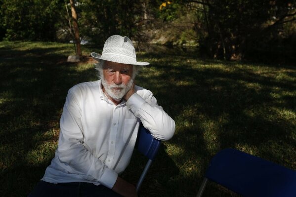 
              California artist David Best talks during an interview with the Associated Press, about how he is building a non-denominational, temporary temple for the anniversary of the Marjory Stoneman Douglas High School shooting massacre, on Tuesday, Feb. 5, 2019 in Coral Springs, Fla. This creation he is calling "The Temple of Time" to commemorate the indefinite period it will take for the community to come to grip with the slayings. He rejected "The Temple of Healing" because that is impossible for the victims and their families. (AP Photo/Brynn Anderson)
            