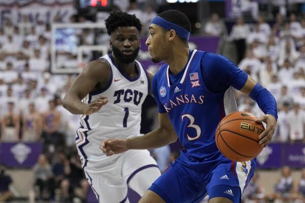 Kansas guard Dajuan Harris Jr. (3) looks for an opening to the basket as TCU's Mike Miles Jr. (1) defends in the first half of an NCAA college basketball game, Monday, Feb. 20, 2023, in Fort Worth, Texas. (AP Photo/Tony Gutierrez)