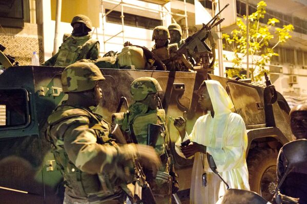 FILE - A woman welcomes ECOWAS Senegalese troops as they take position near the state house in the Gambian capital Banjul Jan. 22, 2017. West Africa's regional bloc known as ECOWAS has threatened the use of force in reinstating the president of Niger after he was deposed by his military but how the bloc would carry out the threat remains unclear, with a military deployment on the table. (AP Photo/Jerome Delay, File)