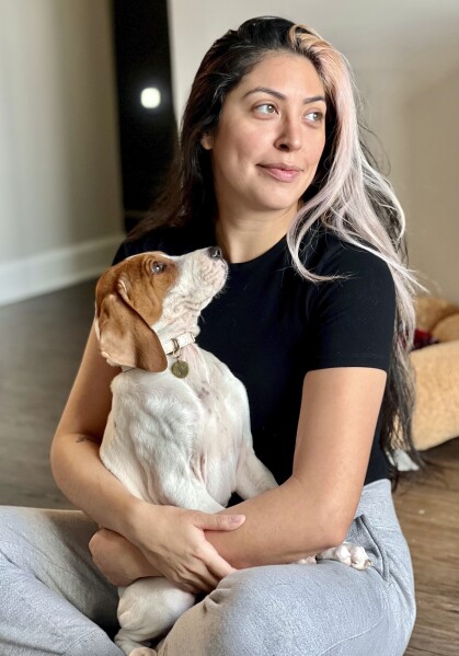 Kristie Pereira and her dog Beau pose for a photo in Laurel, Md., in January 2023. Pereira is seeking answers after the sick dog she took to a shelter to have euthanized turned up more than a year later on a rescue adoption site. (Kristie Pereira via AP)