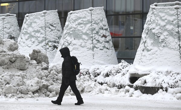 A man walks on the street in freezing temperatures in Helsinki, Wednesday, Jan. 3, 2024. Finland is experiencing cold weather with -40c degrees in the North Finland and capital Helsinki with -15c degrees. (Heikki Saukkomaa/Lehtikuva via AP)