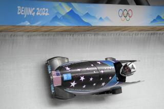 Elana Meyers Taylor, of the United States, drives her bobsled during a women's monobob training heat at the 2022 Winter Olympics, Thursday, Feb. 10, 2022, in the Yanqing district of Beijing. (AP Photo/Mark Schiefelbein)