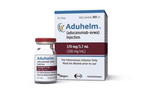 This image provided by Biogen on Monday, June 7, 2021 shows a vial and packaging for the drug Aduhelm.  (Biogen via AP)
