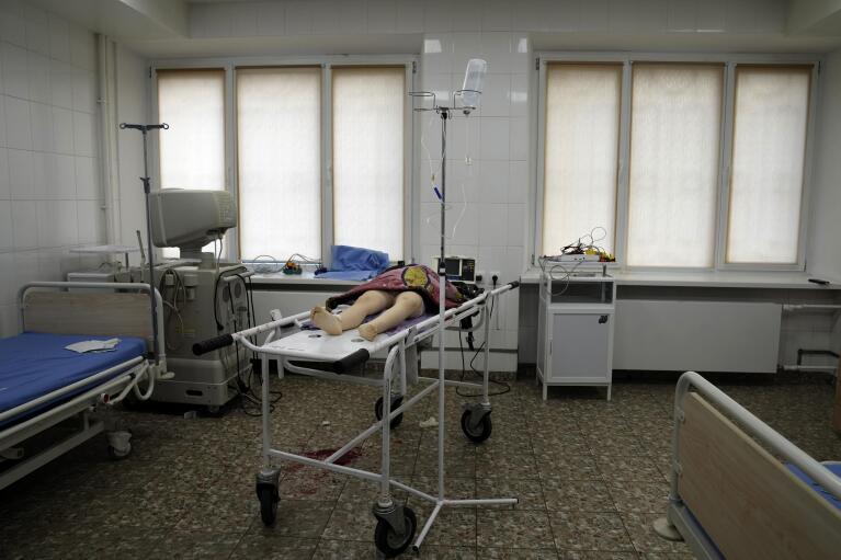 The lifeless body of a girl killed during shelling at a residential area lies on a medical cart at the city hospital of Mariupol, eastern Ukraine, Sunday, Feb. 27, 2022. (AP Photo/Evgeniy Maloletka)