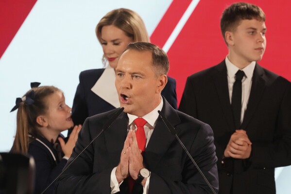 Presidential candidate Karol Nawrocki, a conservative historian backed by the right-wing Law and Justice party addresses supporters at his headquarters after the presidential election runoff in Warsaw, Poland, Sunday, June 1, 2025. (AP Photo/Czarek Sokolowski)