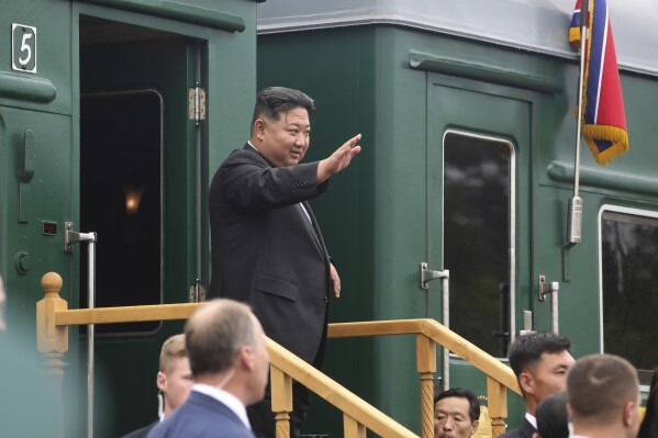 In this photo released by Government of Primorsky Krai Region, North Korea's leader Kim Jong Un waves as he boards his train prior to leaving Artyom, near Vladivostok, Russian Far East on Sunday, Sept. 17, 2023. (Government of Primorsky Krai Region via AP)