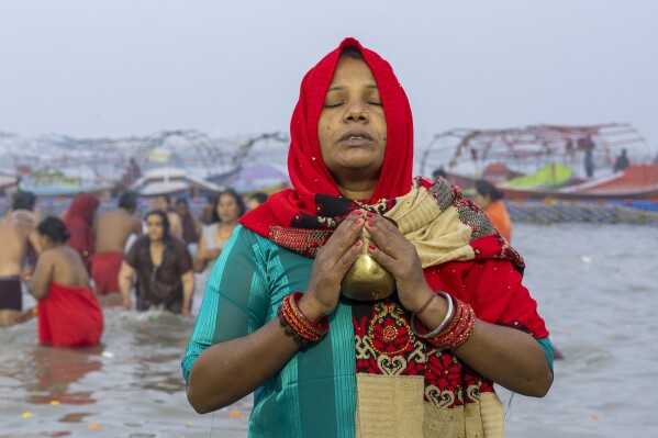 A Hindu pilgrim prays after bathing at the confluence of the Ganges, the Yamuna, and the Saraswati rivers on the first day of the 45-day-long Maha Kumbh festival in Prayagraj, India, Monday, Jan. 13, 2025. (AP Photo/Ashwini Bhatia)