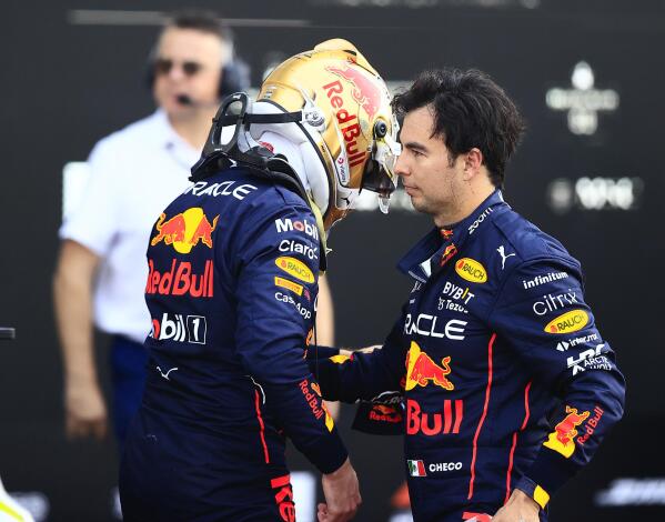 Red Bull driver Max Verstappen, of the Netherlands, left, and teammate Sergio Perez, of Mexico, greet each other at the end of the qualifying run of the Formula One Mexico Grand Prix at the Hermanos Rodriguez racetrack in Mexico City, Saturday, Oct. 29, 2022. Verstappen won pole position and Perez cam in fourth. (Carlos Perez Gallardo/Pool via AP)