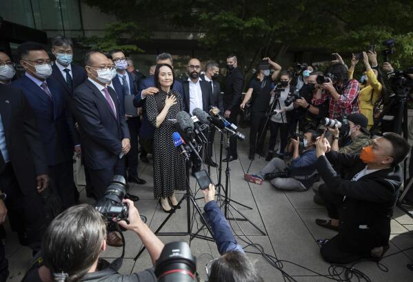 Meng Wanzhou, chief financial officer of Huawei, prepares to read a statement outside B.C. Supreme Court in Vancouver, British Columbia, Friday, Sept. 24, 2021. (Darryl Dyck/The Canadian Press via AP)
