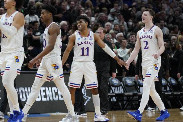 Kansas' Remy Martin and Christian Braun celebrate after the second half of a college basketball game in the Sweet 16 round of the NCAA tournament against Providence Friday, March 25, 2022, in Chicago. Kansas won 66-61. (AP Photo/Nam Y. Huh)