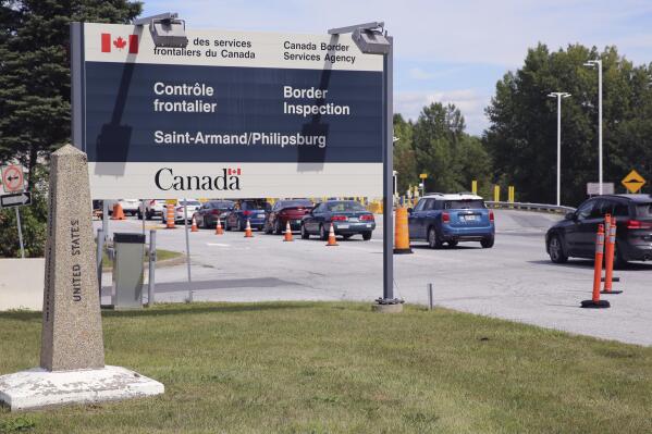 Cars pass a monument marking the border between the United States and Canada on Wednesday, Sept. 1, 2021, at Highgate Springs, Vt. U.S. Sen. Patrick Leahy (D-VT) and Robin Carnahan, the administrator of the U.S. General Services Administration, visited the port of entry with Canada to promote a $3 billion plan to build or modernize more than 30 land ports of entry across the US. (AP Photo/Wilson Ring)