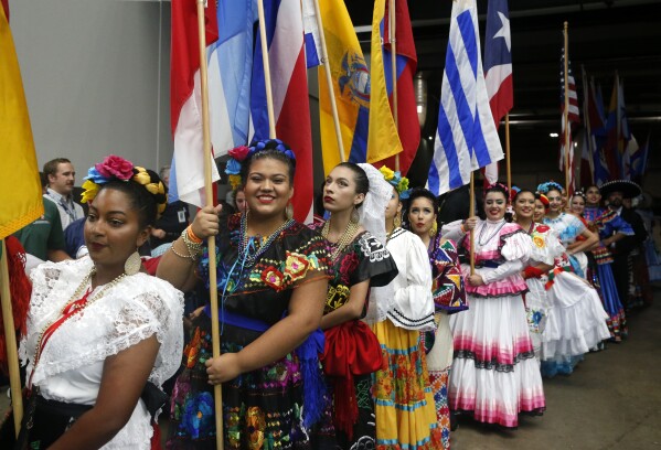 FILE - Folklorico dancers and entertainers participate in a Hispanic Heritage Month celebration before an NFL football game between the Los Angeles Rams and Dallas Cowboys, Oct. 1, 2017, in Arlington, Texas. Hispanic history and culture take center stage across the U.S. for National Hispanic Heritage Month. The celebration recognizes contributions made by Hispanic Americans, the fastest-growing racial or ethnic minority according to the Census, and with a U.S. population of over 63 million people, there will be a plethora of Hispanic Heritage Month celebrations all over the country starting Friday, Sept. 15, 2023. (AP Photo/Michael Ainsworth, File)