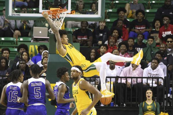 Baylor forward Jalen Bridges dunks over the McNeese State defense in the first half of an NCAA college basketball game, Wednesday, Nov. 23, 2022, in Waco, Texas. (AP Photo/Rod Aydelotte)