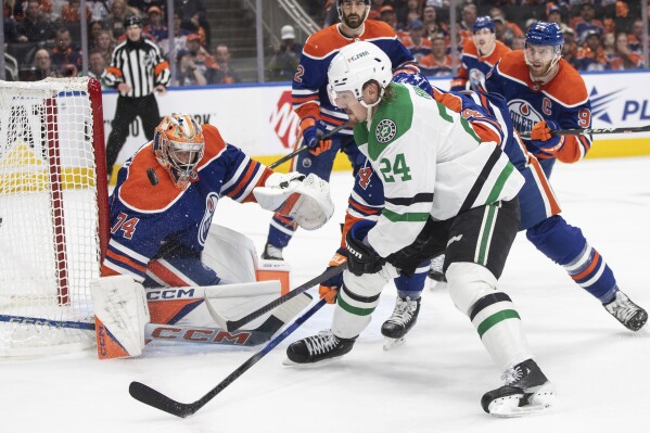 Dallas Stars' Roope Hintz (24) is stopped by Edmonton Oilers goaltender Stuart Skinner (74) during the first period of Game 3 of the NHL hockey Western Conference Final in Edmonton, Alberta, Monday, May 27, 2024. (Jason Franson/The Canadian Press via AP)