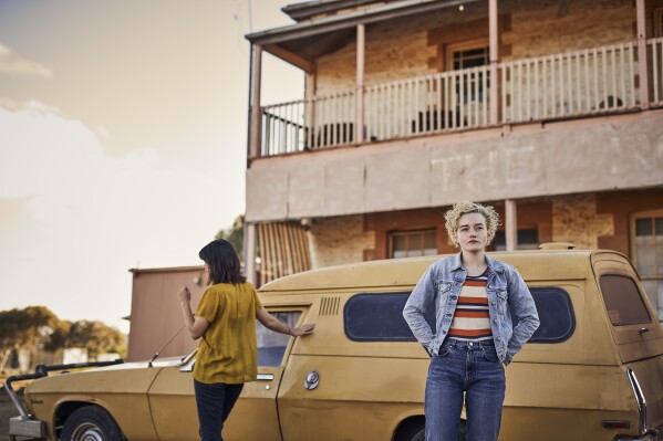 This image released by Neon shows Jessica Henwick, left, and Julia Garner in a scene from "The Royal Hotel." (Neon via AP)